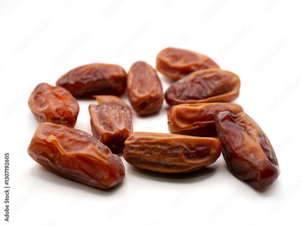 Close-up image of Tunisian dates isolated on a clean white background Close-up image of Tunisian dates isolated on a clean white background