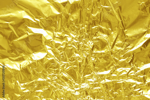 Shiny gold foil texture background, pattern of yellow wrapping paper with crumpled and wavy. photo