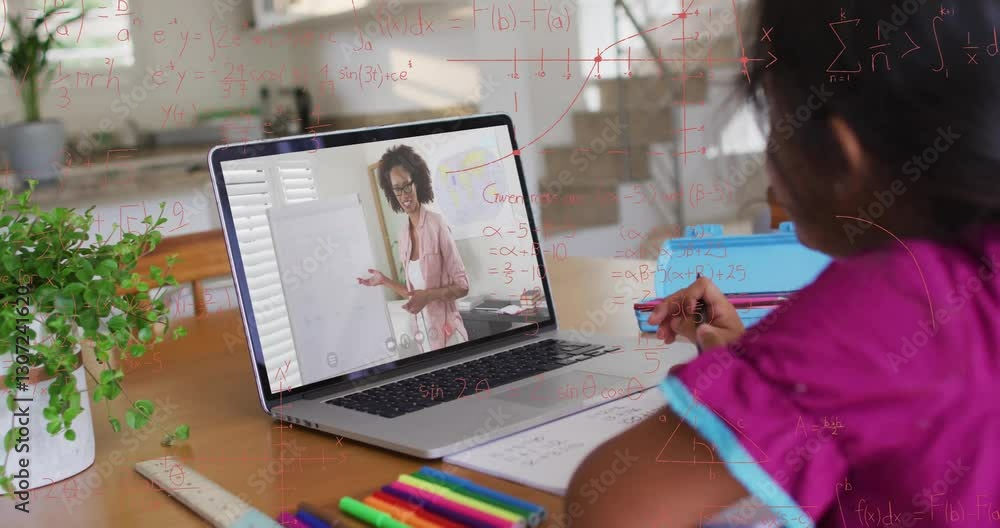In school, child learning math through animation on laptop with colorful stationery In school, child learning math through animation on laptop with colorful stationery