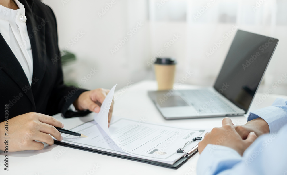 Business people hold a resume and talk to job applicants for job interviews about careers and Their personal history in the company. Recruitment concepts Business people hold a resume and talk to job applicants for job interviews about careers and Their personal history in the company. Recruitment concepts