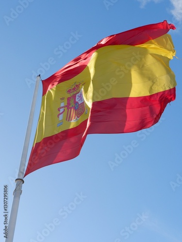 Flag of Spain on the pole moving by wind photo