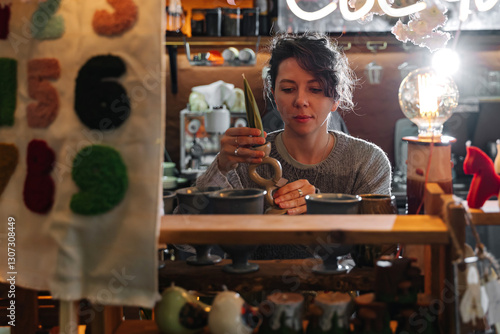 Картината върху платно Woman browsing handmade crafts at artisan market