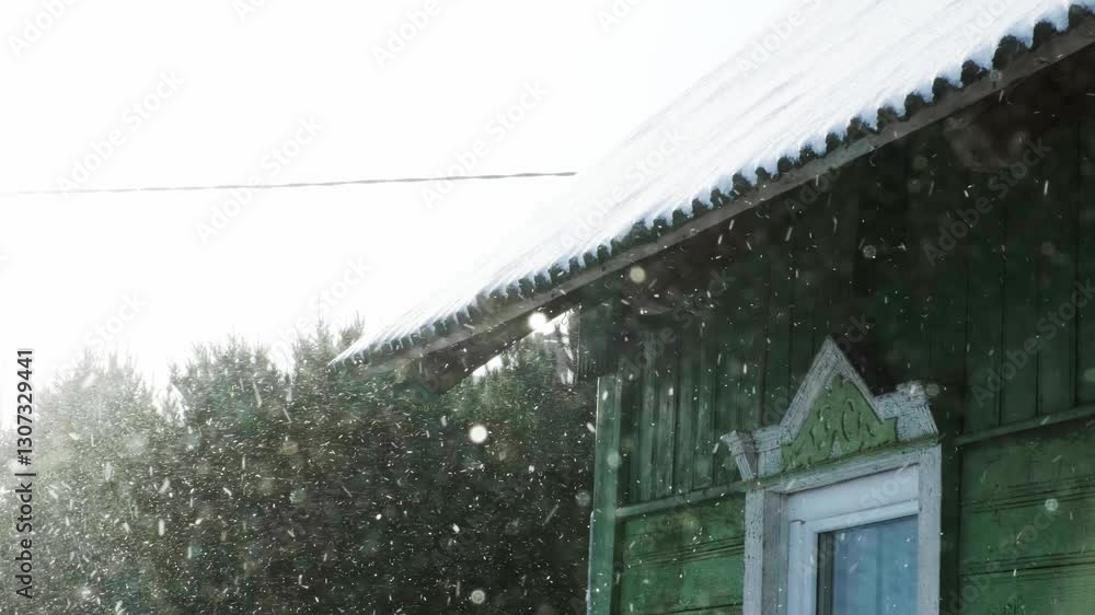 View of an old wooden house with painted green boards. Winter is sweeping. Northern village. Concept of nostalgia. Russian hinterland. Soviet village. View of an old wooden house with painted green boards. Winter is sweeping. Northern village. Concept of nostalgia. Russian hinterland. Soviet village.