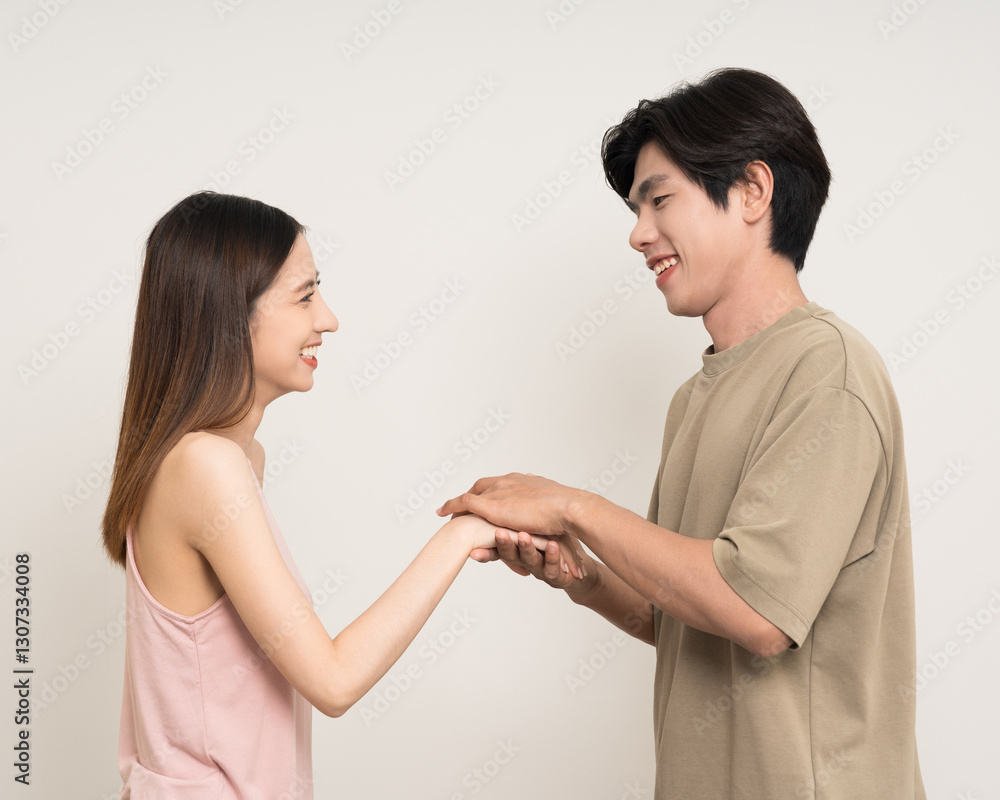 Happy asian couple attractive in various action gesture standing on isolated white background. Cheerful Smiling young man and woman holding hands Happy asian couple attractive in various action gesture standing on isolated white background. Cheerful Smiling young man and woman holding hands
