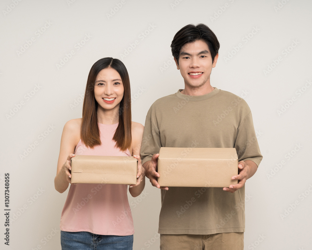 Happy asian couple attractive in various action gesture receive the parcel box cardboard delivery on isolated white background. Cheerful Smiling young man and woman holding box parcel of moving house