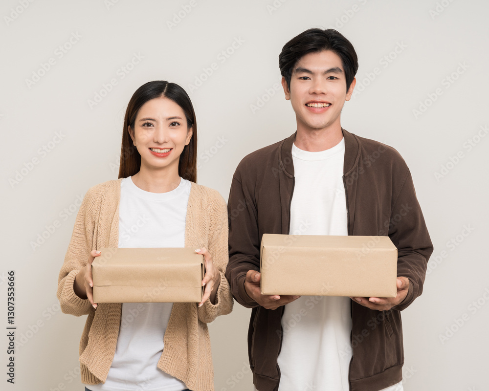 Happy asian couple attractive in various action gesture receive the parcel box cardboard delivery on isolated white background. Cheerful Smiling young man and woman holding box parcel of moving house Happy asian couple attractive in various action gesture receive the parcel box cardboard delivery on isolated white background. Cheerful Smiling young man and woman holding box parcel of moving house