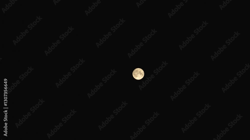 A vivid, glowing full moon captured in mid-orbit against a stark black sky. The detailed surface showcases craters and ridges, highlighting the astronomical beauty and movement of the celestial body. A vivid, glowing full moon captured in mid-orbit against a stark black sky. The detailed surface showcases craters and ridges, highlighting the astronomical beauty and movement of the celestial body.