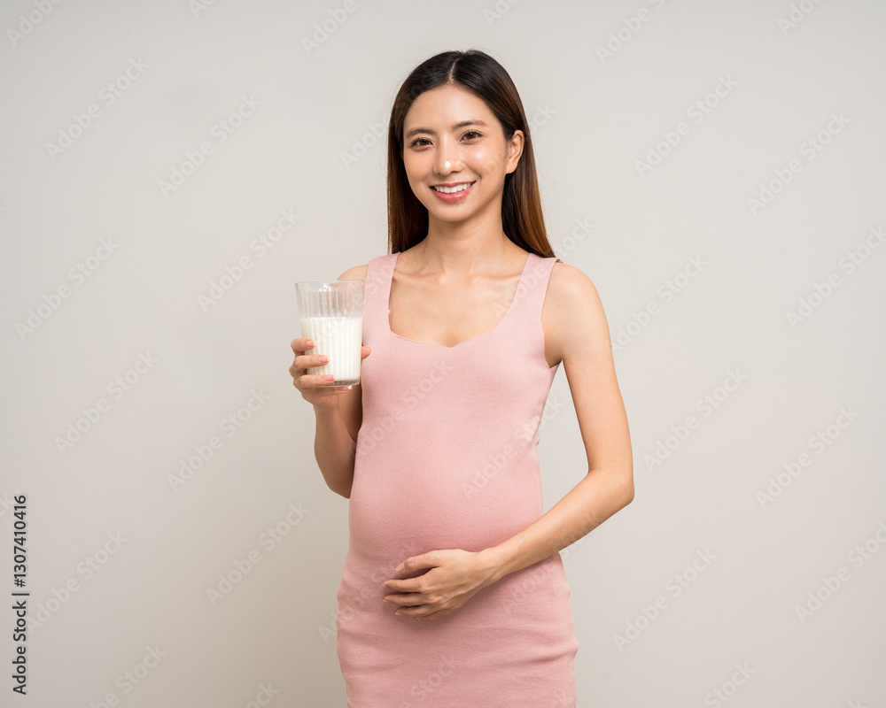 Happy Pregnant asian woman stroking touch belly motherhood drinking milk on isolated background. Family planning maternity and pregnancy with insurance for child health. Happy Pregnant asian woman stroking touch belly motherhood drinking milk on isolated background. Family planning maternity and pregnancy with insurance for child health.