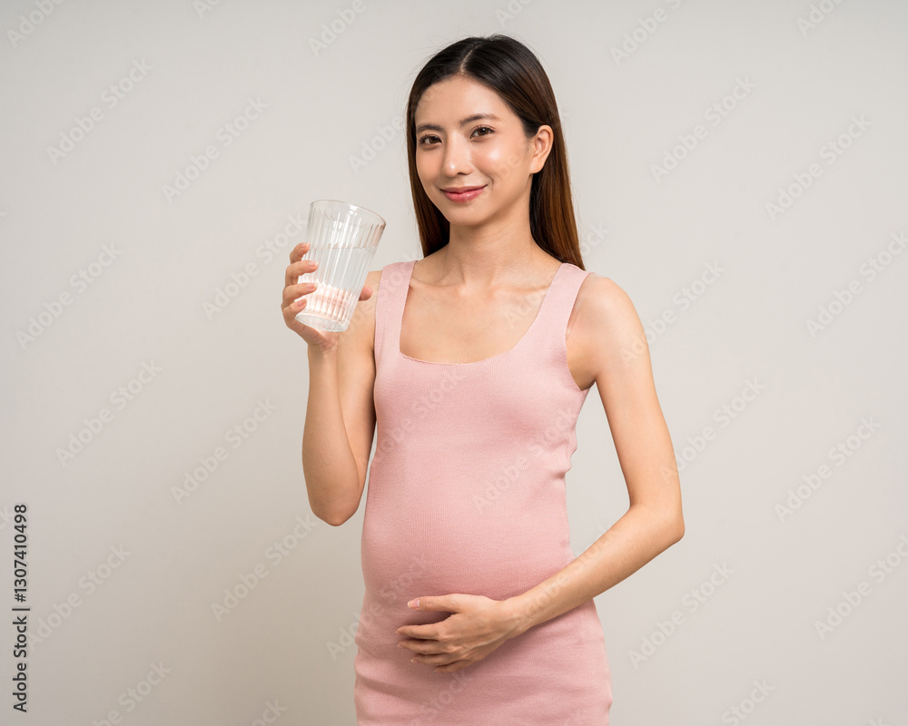 Happy Pregnant asian woman stroking touch belly motherhood drinking milk on isolated background. Family planning maternity and pregnancy with insurance for child health. Happy Pregnant asian woman stroking touch belly motherhood drinking milk on isolated background. Family planning maternity and pregnancy with insurance for child health.