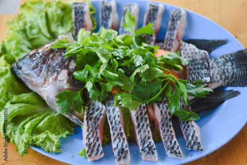 Photography Place the fish on the greens and garnish with fresh herbs such as parsley or cilantro
