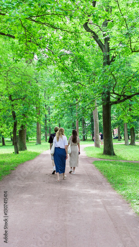 Wallpaper Mural Group of people are walking down a path in a park Torontodigital.ca