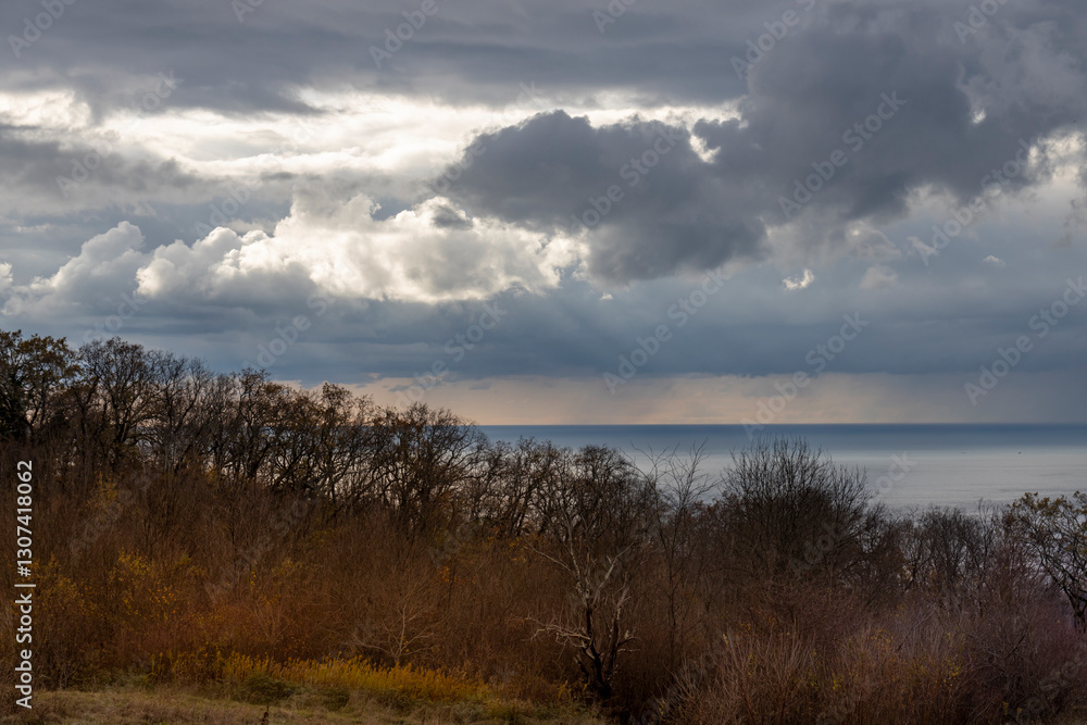 Cloudy sky with a bright sun peeking through the clouds Cloudy sky with a bright sun peeking through the clouds