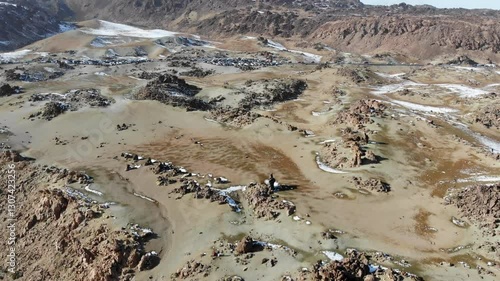 Aerial view footage, drone approach shot: beautiful volcanic landscape and colorful rocky mountains with snow. 4K video of Volcano Teide, solidified lava flows from above. Tenerife, Canary islands