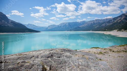 Fototapeta Naklejka Na Ścianę i Meble -  Wide blue lake in a wild rustic mountain valley 