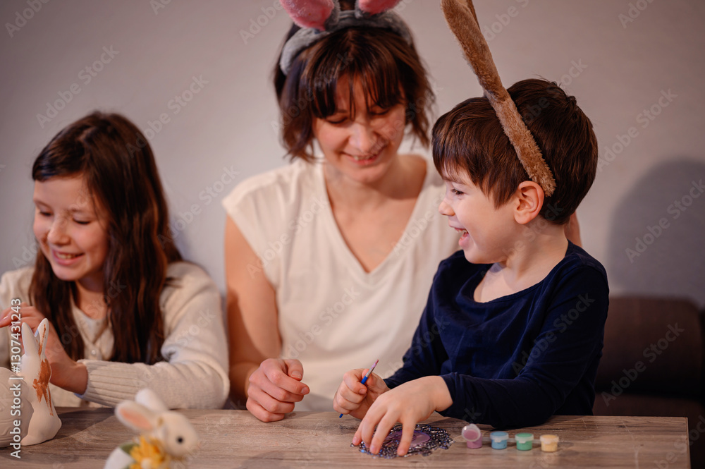 Naklejka premium Happy Family Painting Easter Decorations Together