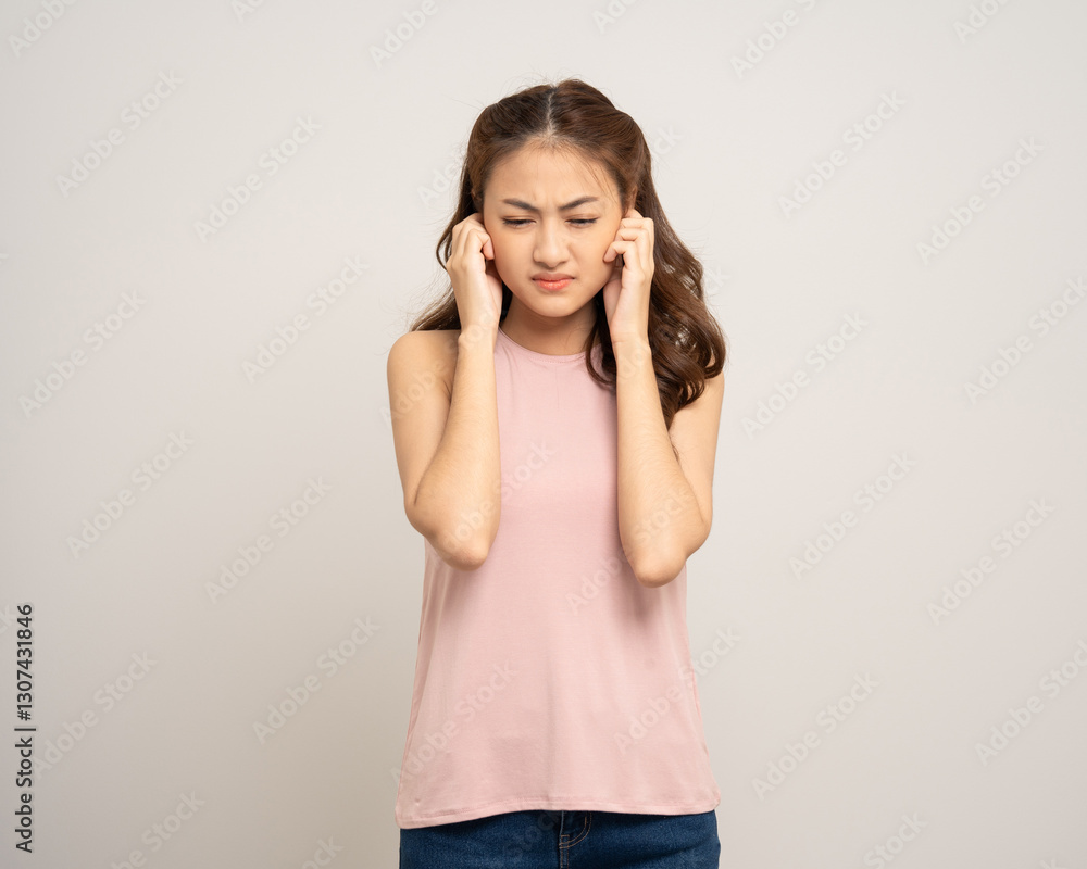 Young Woman stressed and frustrated covering her ears with her hands due to loud noise. Annoyed noise sound pollution. Asian Woman blocking ears Young Woman stressed and frustrated covering her ears with her hands due to loud noise. Annoyed noise sound pollution. Asian Woman blocking ears