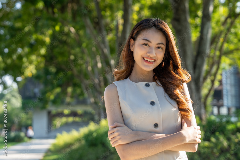 Young asian woman standing posing at public park. Happy attractive charming asian female living in city. People and lifestyle. Young asian woman standing posing at public park. Happy attractive charming asian female living in city. People and lifestyle.