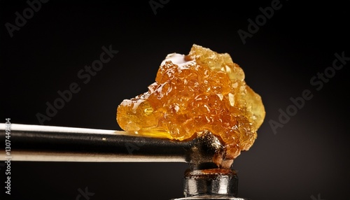 live rosin on a dab tool with a black background