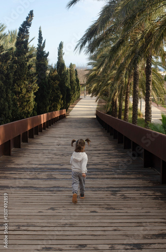 little girl walking on the bridge