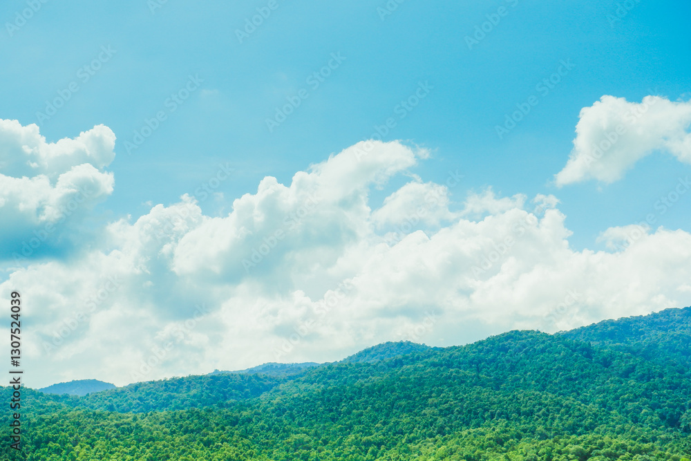Obraz premium Blue sky with the mountains view on a sunny summer day mountain silhouettes,Landscape, Beautiful nature view,white cloud in good day and forest background.