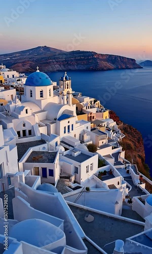 Aerial Drone Vertical View of Santorini at Sunset – Whitewashed Buildings, Blue-Domed Churches, Volcanic Cliffs, and the Aegean Sea in Golden Light