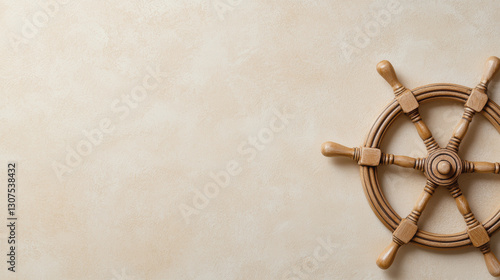 Wooden ship wheel on textured beige background, evoking nautical themes and adventure