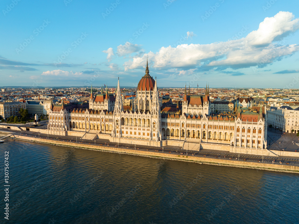 Fototapeta premium Aerial view Residence of Hungarian Parliament, Budapest. National building symbol view from opposite bank of Danube River backdrop of sunset on sunny day in summer. Travel destination. Tourism