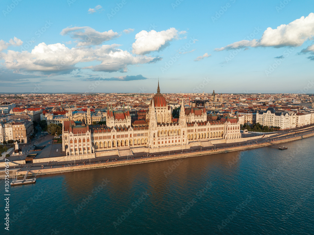 Fototapeta premium Aerial view Residence of Hungarian Parliament, Budapest. National building symbol view from opposite bank of Danube River backdrop of sunset on sunny day in summer. Travel destination. Tourism