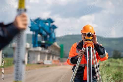 Obraz na plátne The survey team is using a theodolite and road construction plans