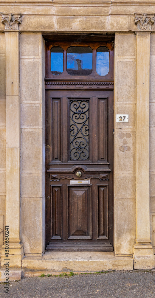 Old building facade featuring wooden door, with stone walls.For the background of your photos and collages Old building facade featuring wooden door, with stone walls.For the background of your photos and collages