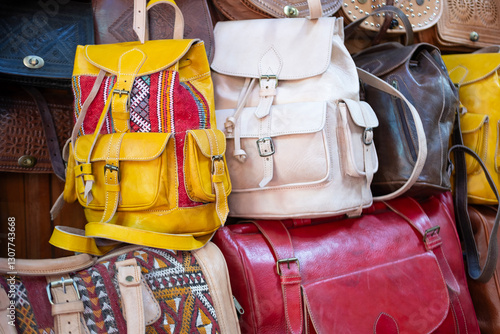 Colorful Vibrant leather handmade Moroccan bags, goods for sale in traditional local souk, story heritage and authentic oriental craftsmanship, artisanal culture Morocco