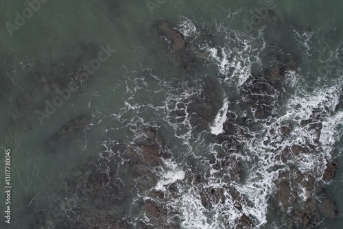 Aerial, Winter’s crashing tidal waves at Down Derry in Cornwall UK