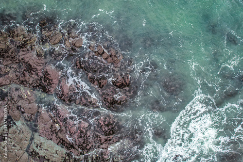 Aerial, Winter’s crashing tidal waves at Down Derry in Cornwall UK