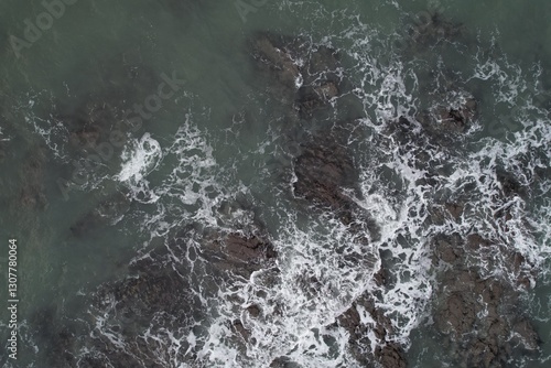 Aerial, Winter’s crashing tidal waves at Down Derry in Cornwall UK