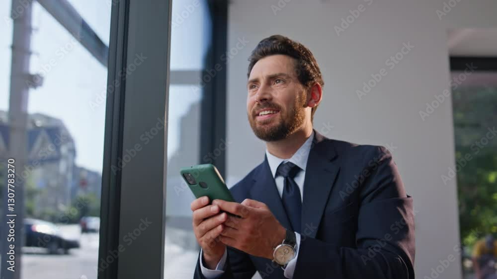 Cheerful man boss texting cell at coffee break in contemporary cafe closeup Cheerful man boss texting cell at coffee break in contemporary cafe closeup