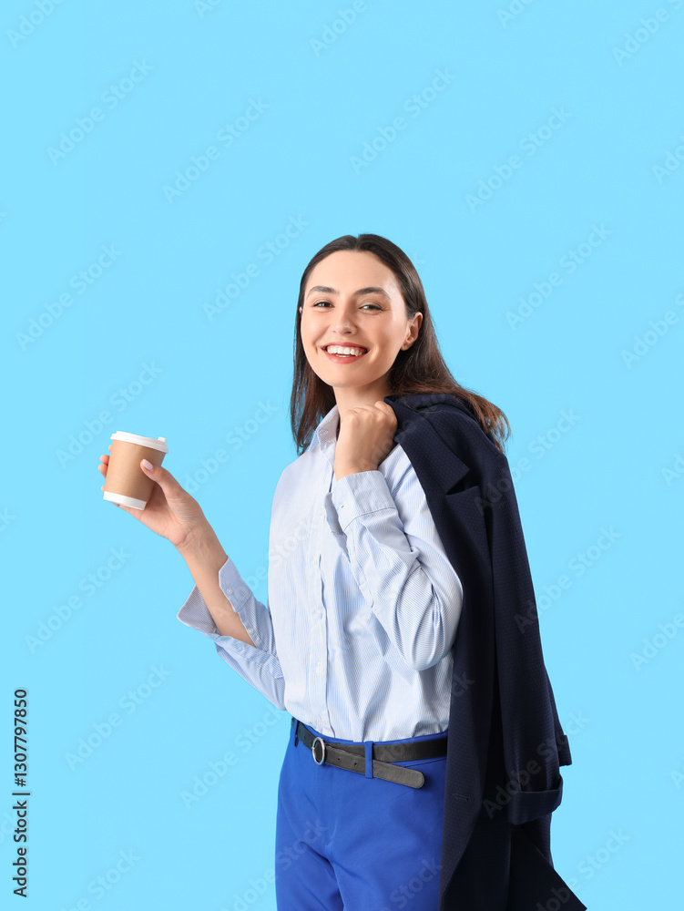 Young woman in stylish suit with cup of coffee on blue background Young woman in stylish suit with cup of coffee on blue background