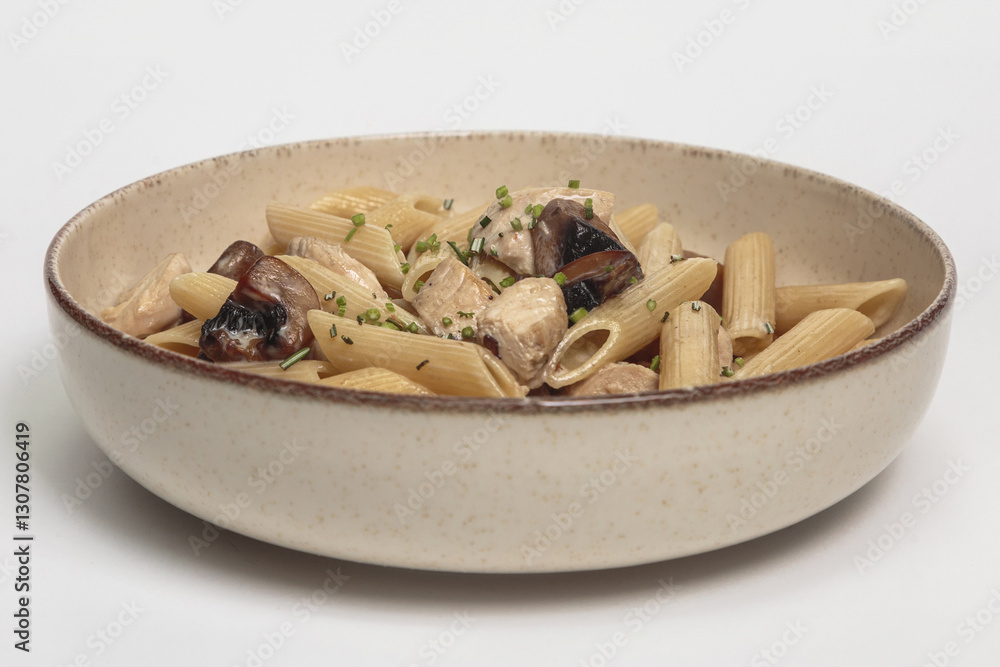 The image shows a bowl of pasta dish. The pasta appears to be penne, a short, cylindrical pasta shape. The image shows a bowl of pasta dish. The pasta appears to be penne, a short, cylindrical pasta shape.
