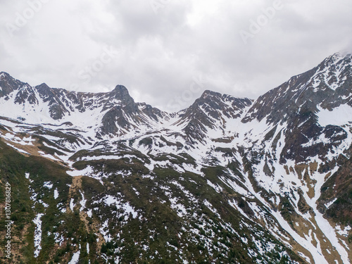 early spring in the mountains, the last snow is melting in the valley
