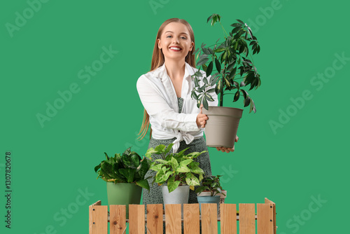 Smiling young woman holding...