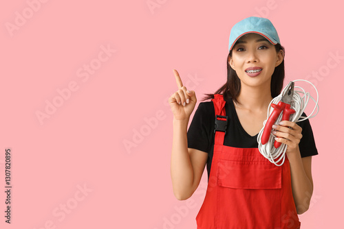 Young female electrician wi...