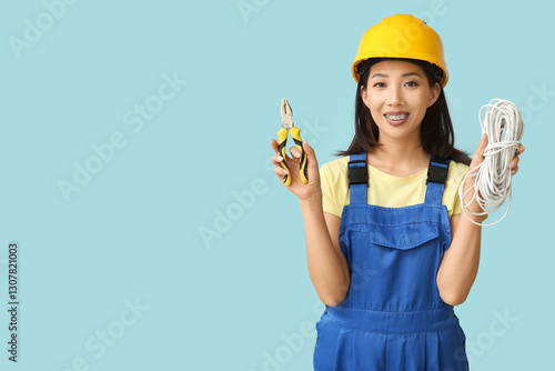 Young female electrician wi...