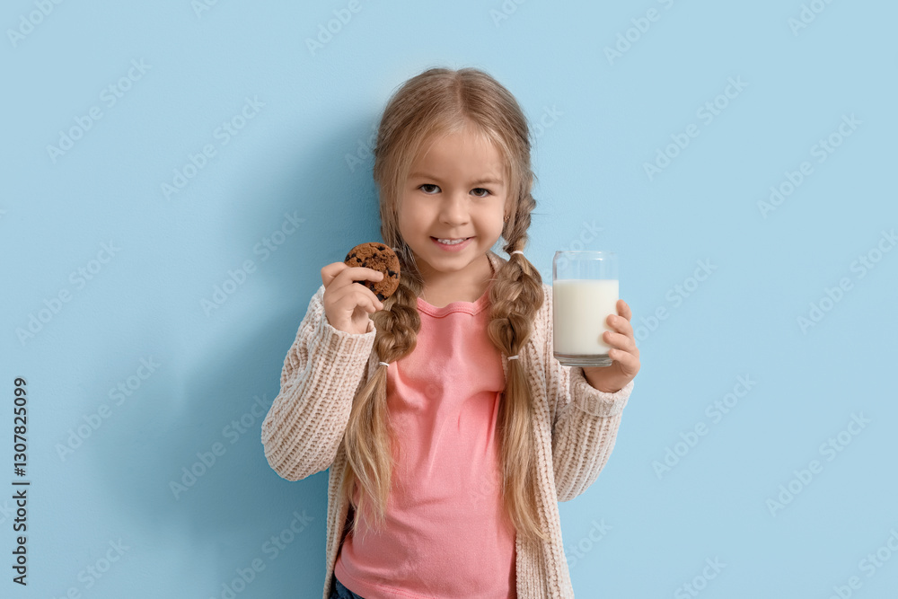 Cute little girl with glass of tasty milk and cookie on blue background Cute little girl with glass of tasty milk and cookie on blue background