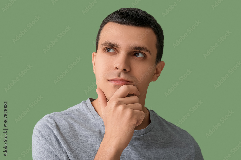 Handsome thoughtful man after shaving on green background Handsome thoughtful man after shaving on green background