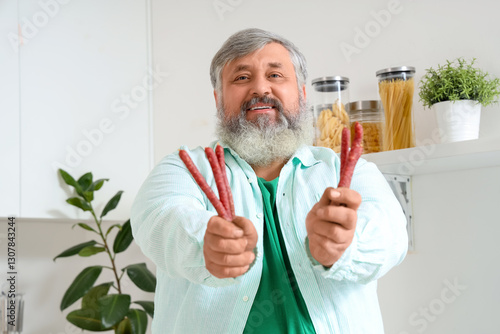 Mature man with tasty sausa...