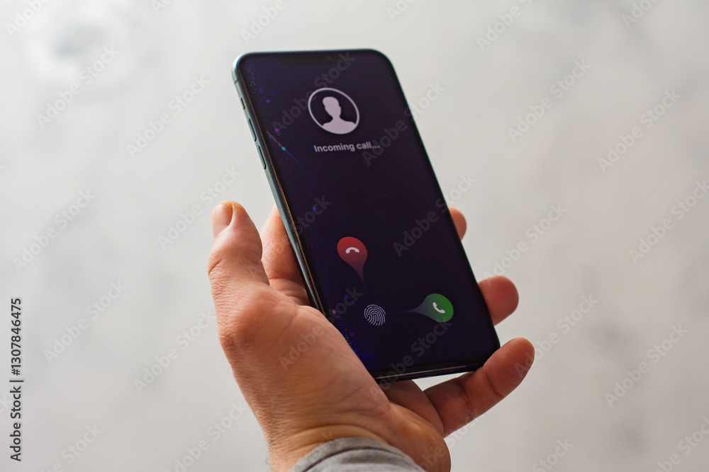 custom made wallpaper toronto digitalClose-up of a hand holding a smartphone with an incoming call screen. Display shows Incoming call with green accept and red decline buttons.