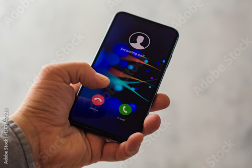 Wallpaper Mural Close-up of a hand holding a smartphone with an incoming call screen. Display shows Incoming call with green accept and red decline buttons. Torontodigital.ca