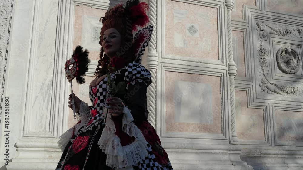 Venice, Italy - People dressed in carnival masks are photographed by tourists in the scenery of the ancient Venetian palaces Venice, Italy - People dressed in carnival masks are photographed by tourists in the scenery of the ancient Venetian palaces