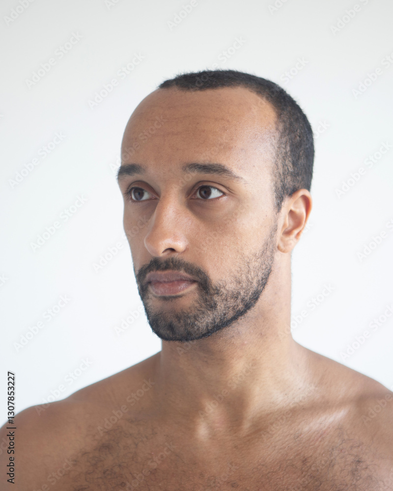 Fototapeta premium Dark-skinned man, head close-up over white background.