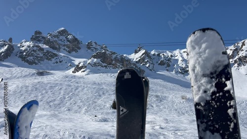 Winter scenery with skis on the gondola going up in ski lift on a snowing day