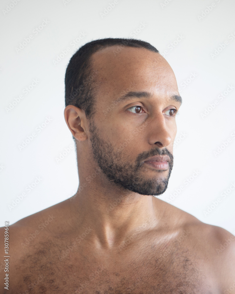 Dark-skinned man, head close-up over white background. Dark-skinned man, head close-up over white background.